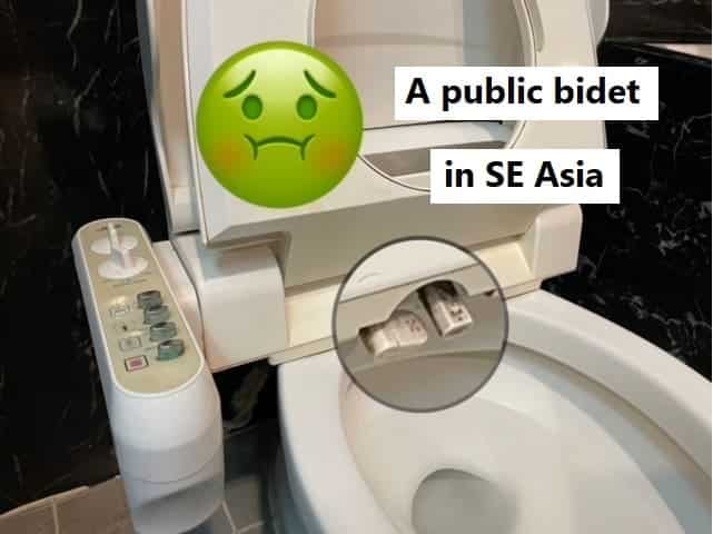 A picture of a bidet in a public restroom. The image zooms in on the dual nozzles that show a significant buildup of dirt and grime.