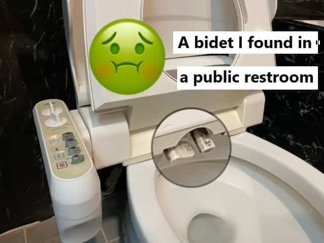A picture of a public toilet with an electric bidet seat. The dual nozzles are zoomed in on, showing signfiicant buildup of grime on the nozzle surfaces.