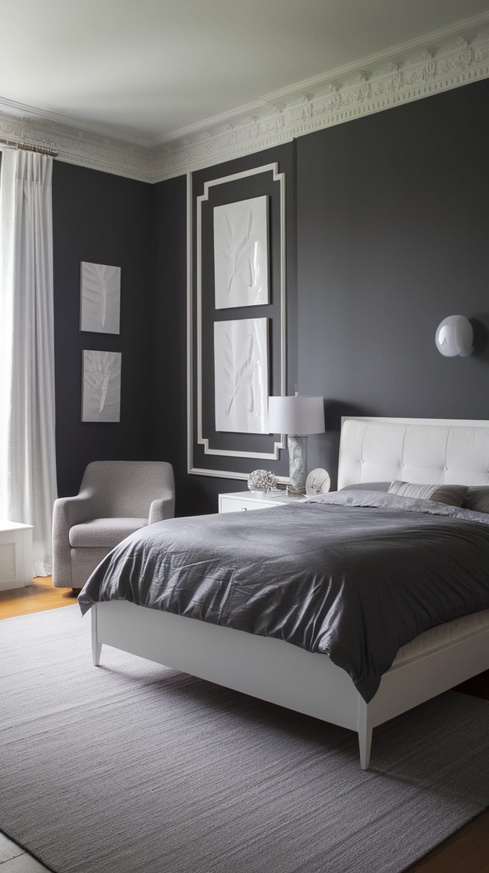 A charcoal gray bedroom featuring white trim and molding, with a modern bed and decor.