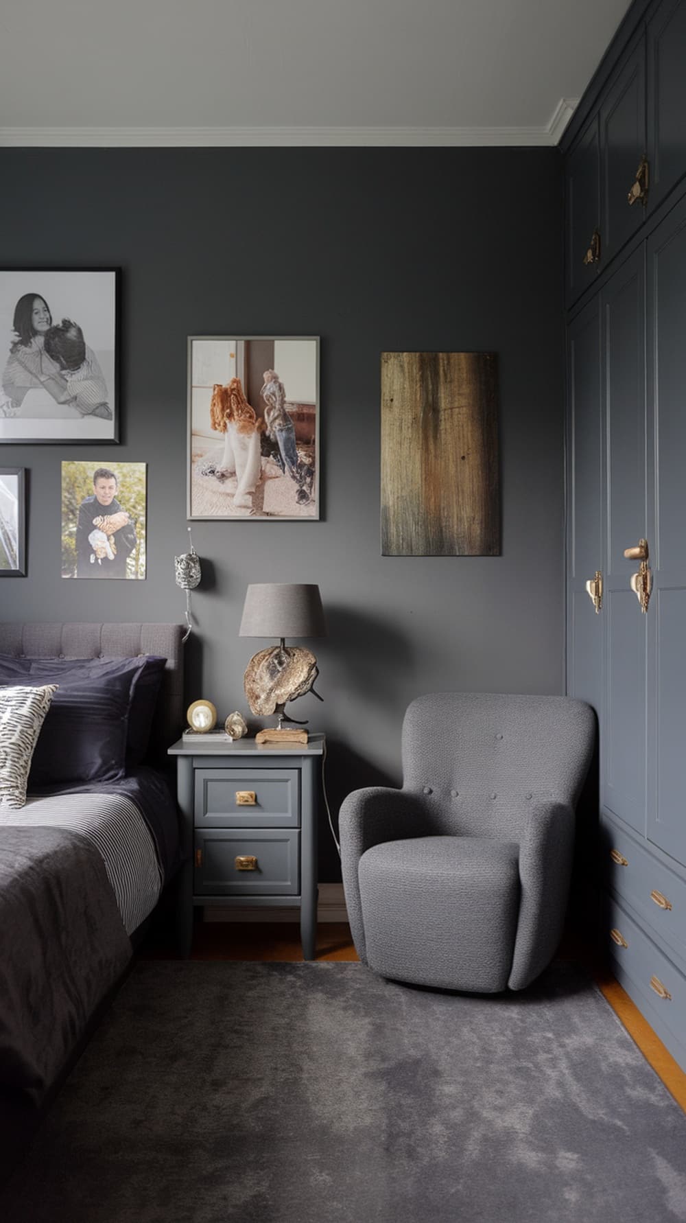 A stylish charcoal gray bedroom featuring personal decorative touches such as framed photos and a unique lamp.