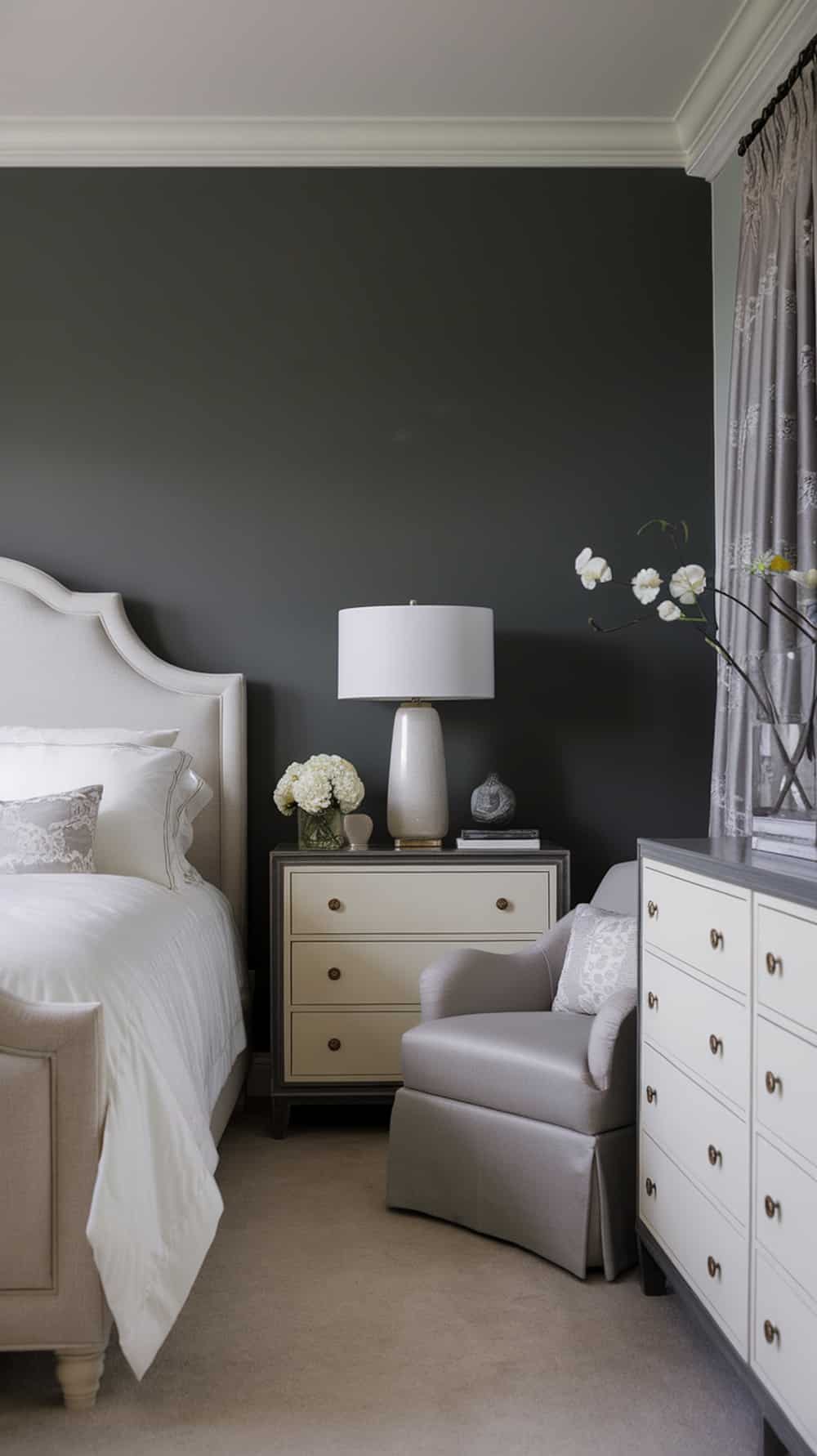 A stylish bedroom featuring a charcoal gray accent wall, light-colored furniture, and decorative elements.