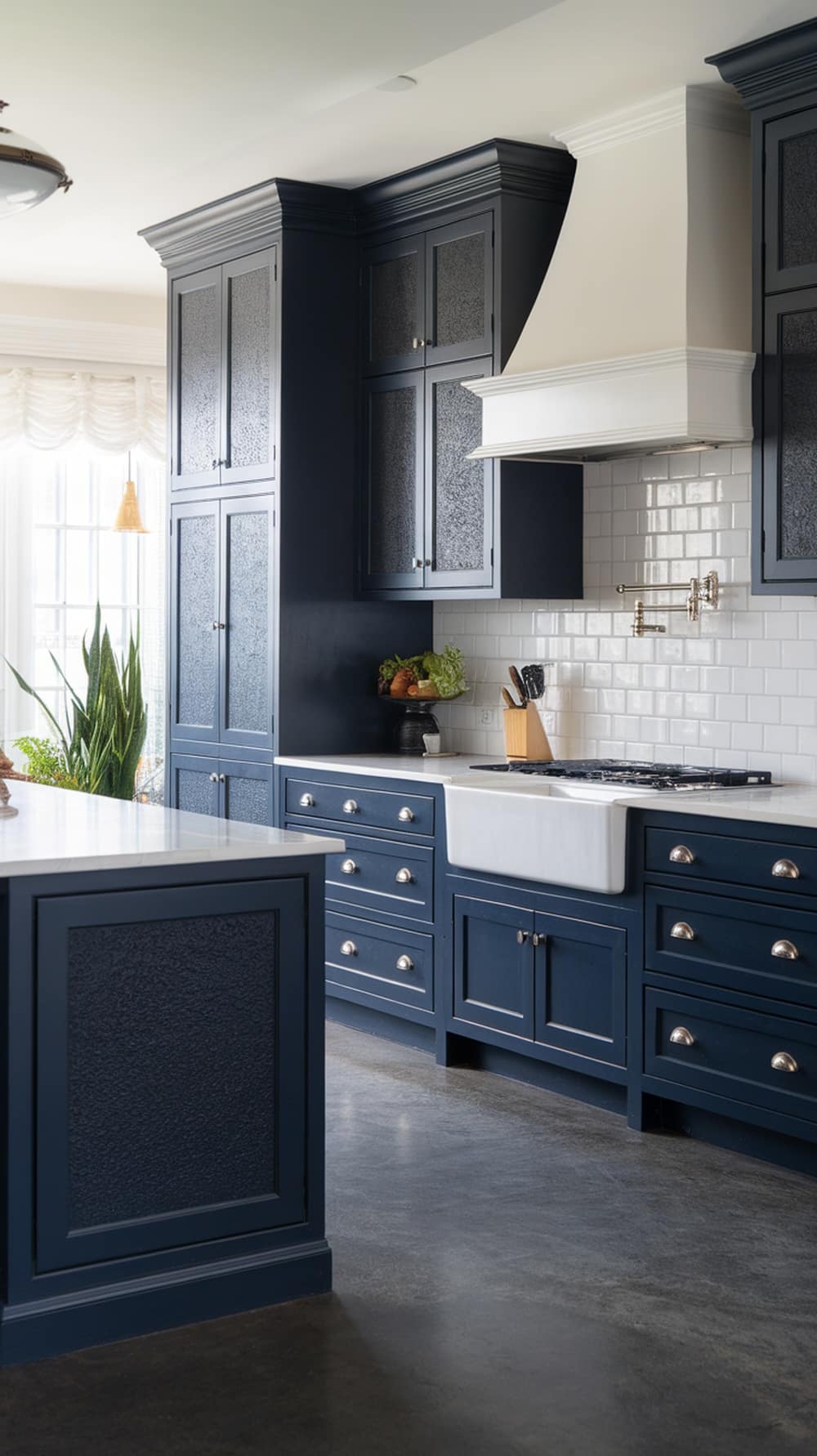 A modern navy blue kitchen featuring textured finishes on cabinets, a white farmhouse sink, and a stylish range hood.