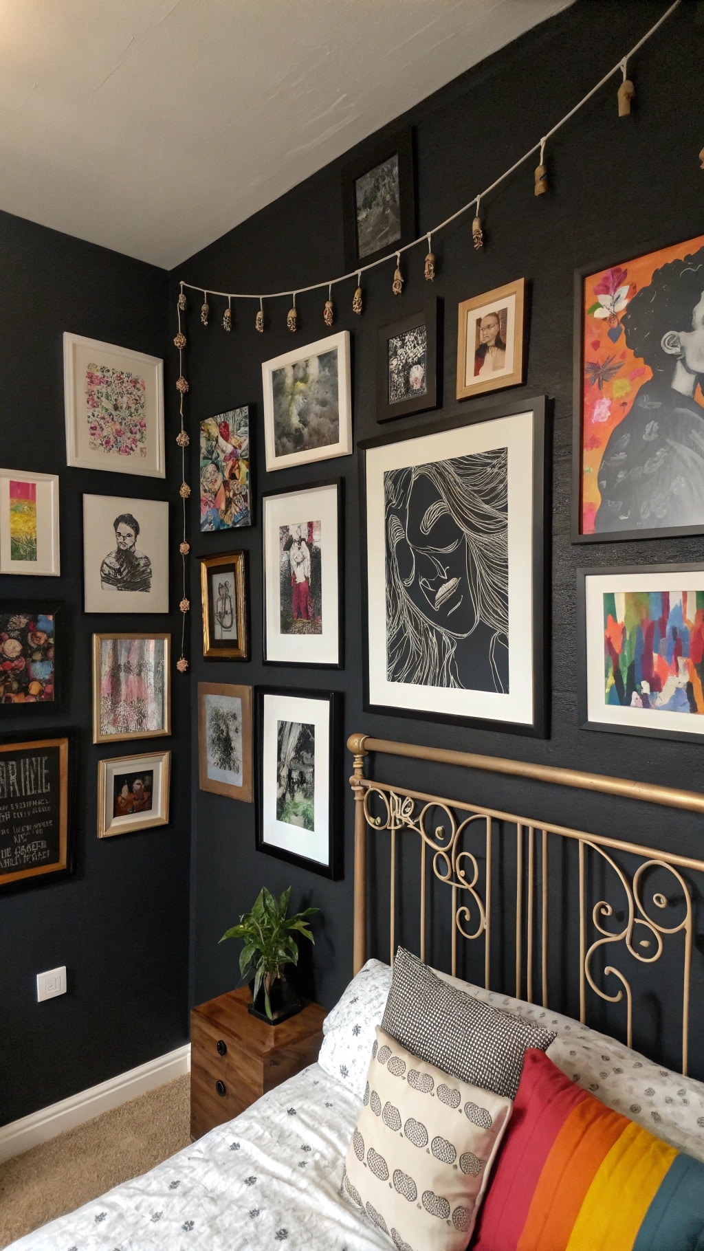 Cozy black bedroom corner with eclectic decor, framed art, and plants